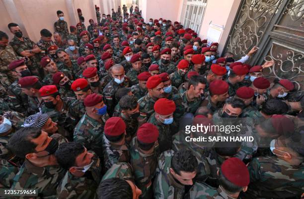 Members of Kurdish Peshmerga security forces wait to cast their votes in Arbil, the capital of the northern Iraqi Kurdish autonomous region, on...