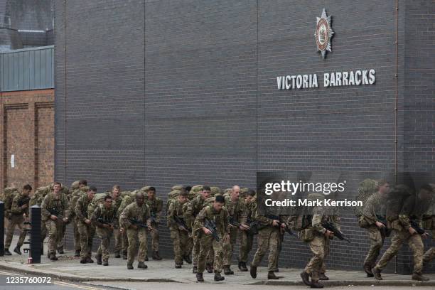 Soldiers return from training with backpacks to Victoria Barracks on 7th October 2021 in Windsor, United Kingdom. Victoria Barracks is home to the...