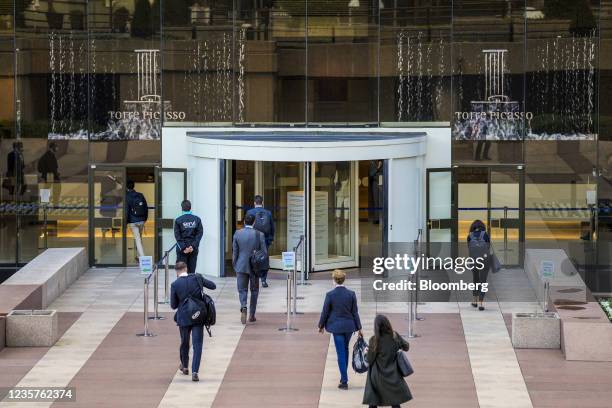 Office workers arrive for work at the Torre Picasso building in the financial district of Madrid, Spain, on Thursday, Oct. 7, 2021....