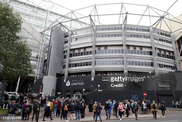 Newcastle United supporters gather to celebrate outside the club's stadium St James' Park in Newcastle upon Tyne in northeast England on October 7...