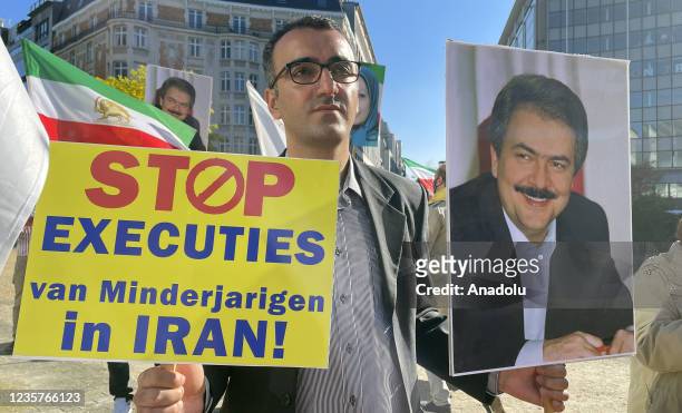 Protesters gather at Schuman Square to stage a protest against executions in Iran ahead of World Day Against the Death Penalty in Brussels, Belgium...