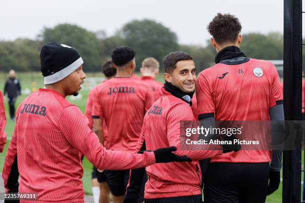 Korey Smith, Yan Dhanda and Rhys Williams of Swansea City walk to the pitch during the Swansea City Training Session at The Fairwood Training Ground...