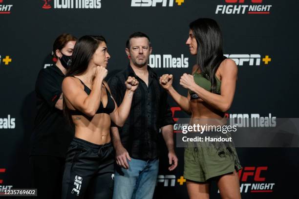 In this UFC handout, Mackenzie Dern and Marina Rodriguez face off during the UFC Fight Night weigh-in at UFC APEX on October 08, 2021 in Las Vegas,...