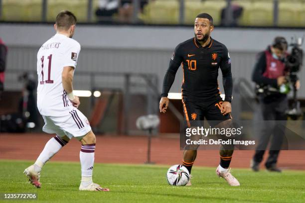 Roberts Savalnieks of Latvia and Memphis Depay of Netherlands battle for the ball during the 2022 FIFA World Cup Qualifier match between Latvia and...
