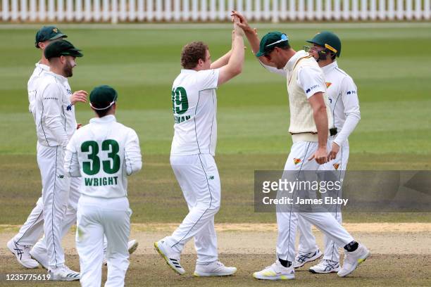 Jarrod Freeman of the Tasmanian Tigers celebrates the wicket of Matthew Renshaw of the Queensland Bulls during day three of the Sheffield Shield...