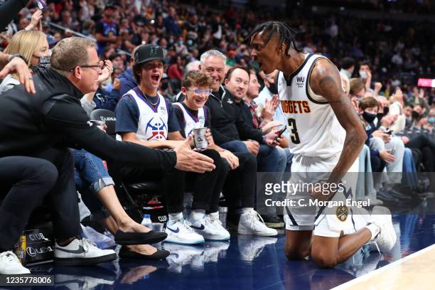 Nah'Shon Hyland of the Denver Nuggets reacts with a fan after hitting a step back jumper and drawing a foul against the Minnesota Timberwolves during...