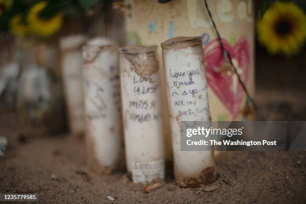 Personal messages from family members are scrawled on candles at a memorial site for Elisha Lucero in Albuquerque, NM on September 29, 2021. CREDIT:...