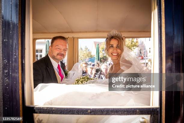 October 2021, Lower Saxony, Bückeburg: The groom, Prince Alexander zu Schaumburg-Lippe, and the bride, Princess Mahkameh zu Schaumburg-Lippe, sit in...