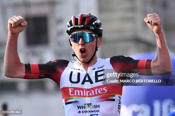 Team UAE Emirates' Tadej Pogacar of Slovenia celebrates as he crosses the finish line of the 115th edition of the giro di Lombardia , a 231 km...