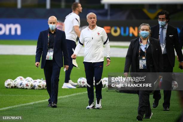 France's coach Didier Deschamps arrives to speaks to the press during a training session at the San Siro Stadium in Milan on October 9 on the eve of...