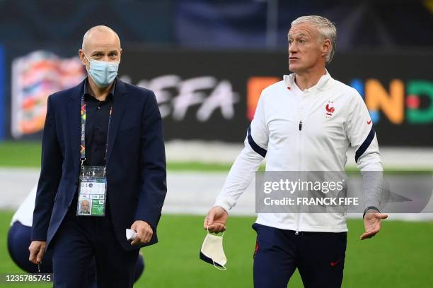 France's coach Didier Deschamps arrives to speaks to the press during a training session at the San Siro Stadium in Milan on October 9 on the eve of...