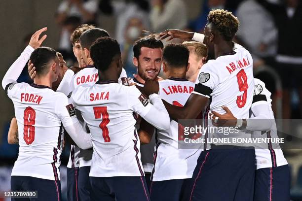 England's defender Ben Chilwell is congratulated by teammates after scoring a goal during the World Cup 2022 qualifier football match between Andorra...