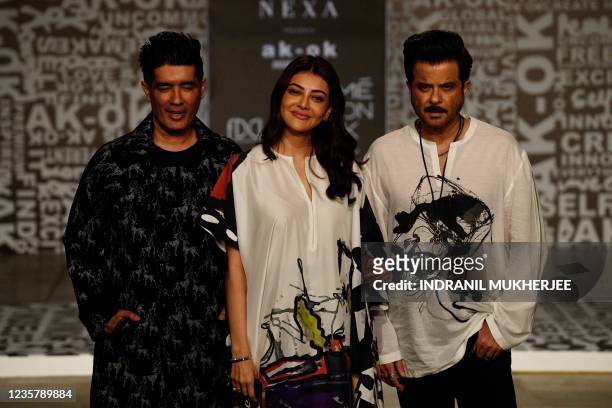 Designer Manish Malhotra , actress Kajal Agarwal and Anil Kapoor pose before a fashion show to present creations by designer Anamika Khanna during...