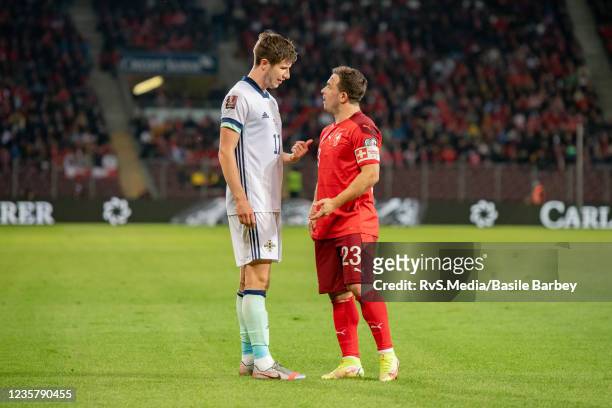 Paddy McNair of Northern Ireland talks with Xherdan Shaqiri of Switzerland during the 2022 FIFA World Cup Qualifier match between Switzerland and...