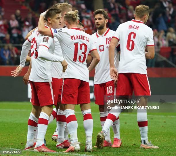 Poland's Krzysztof Piatek is congratulated by teammates after he scored a goal during the FIFA World Cup Qatar 2022 qualifying Group I football match...