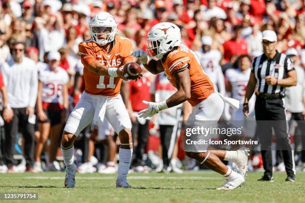 Texas Longhorns quarterback Casey Thompson hands-off the football to running back Bijan Robinson during the Red River Showdown between the Texas...