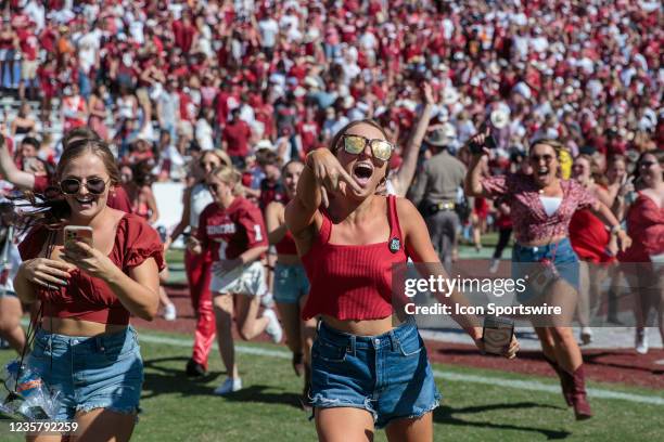 Oklahoma Sooners fans storm the field after the game against the Texas Longhorns on October 9th, 2021 at Cotton Bowl Stadium in Dallas, Texas.