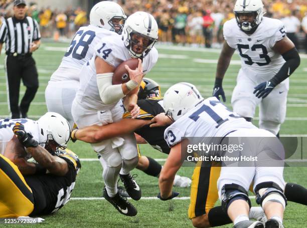 Quarterback Sean Clifford of the Penn State Nittany Lions drives for a touchdown during the first half against linebacker Jack Campbell of the Iowa...