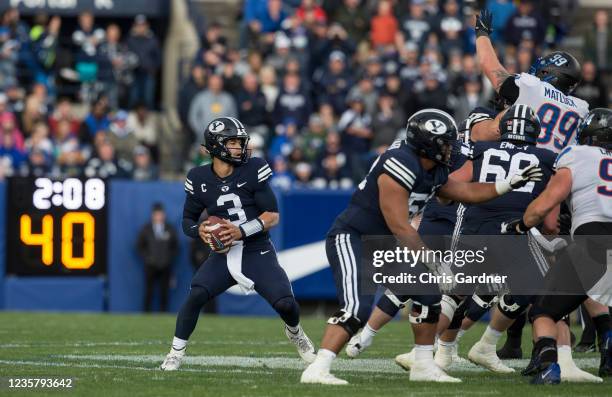 Jaren Hall of the BYU Cougars drops into the pocket to pass under pressure from the Boise State Broncos during their game October 9, 2021 at LaVell...