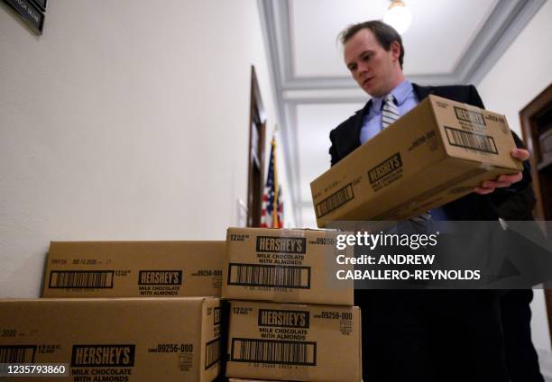In this file photo taken on January 24 staff members load boxes of Hershey's chocolate bars onto pallets outside of office of Senator Pat Toomey,...
