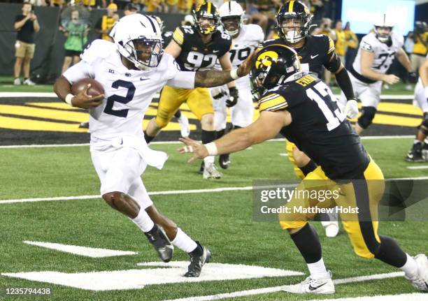 Quarterback TaQuan Roberson of the Penn State Nittany Lions goes up the field during the second half against defensive end Joe Evans of the Iowa...