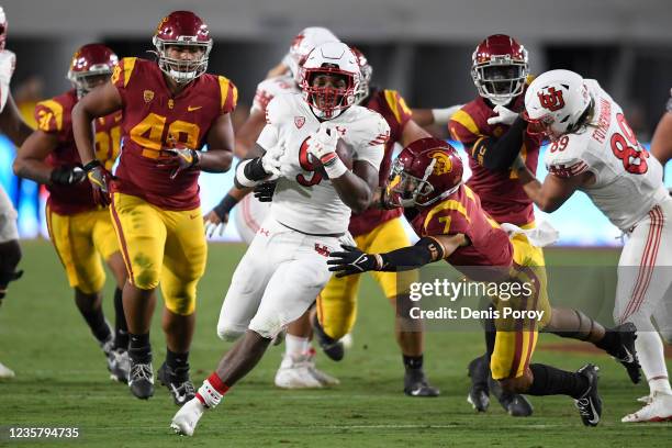 Tavion Thomas of the Utah Utes breaks the tackle of Chase Williams of the USC Trojans on second half touchdown run during a college football game at...