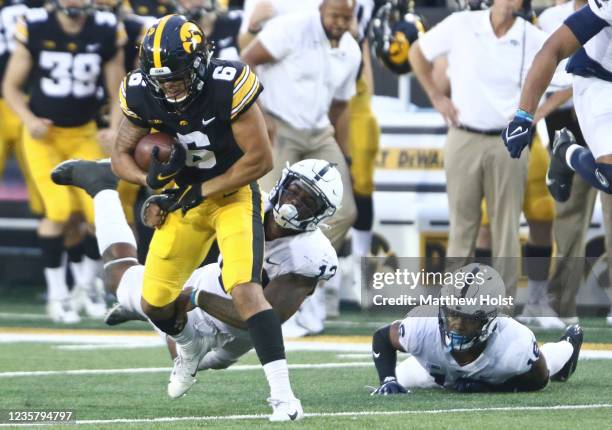 Wide receiver Keagan Johnson of the Iowa Hawkeyes breaks a tackle during the second half by linebacker Ellis Brooks of the Penn State Nittany Lions...
