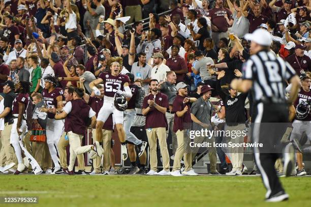 The Aggie bench erupts in celebration as Texas A&M Aggies wide receiver Jalen Preston returns a sceond half kickoff for a touchdown during a game...