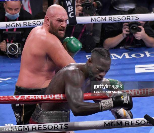 Tyson Fury delivers a right cross hit during the 11th round and KO's Deontay Wilder for the World Heavyweight Championship III trilogy fight at...