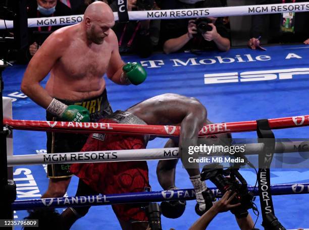 Tyson Fury delivers a right cross hit during the 11th round and KO's Deontay Wilder for the World Heavyweight Championship III trilogy fight at...