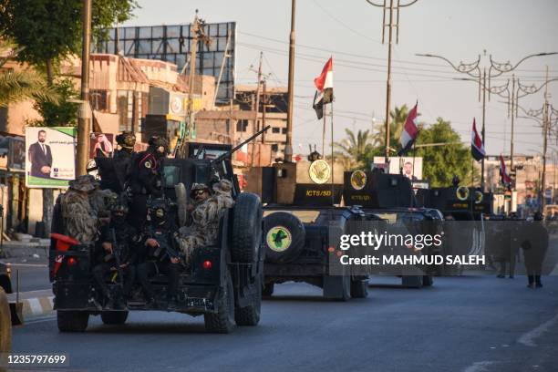 Members of the Iraqi security forces patrol in the streets of Tikrit north of the capital Baghdad, on October 10 during the country's early...