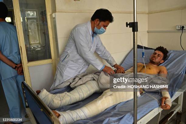 Doctor attends a victim who was injured in October 8 suicide bombing at the Gozar-e-Sayed mosque, inside a regional hospital in Kunduz on October 10,...