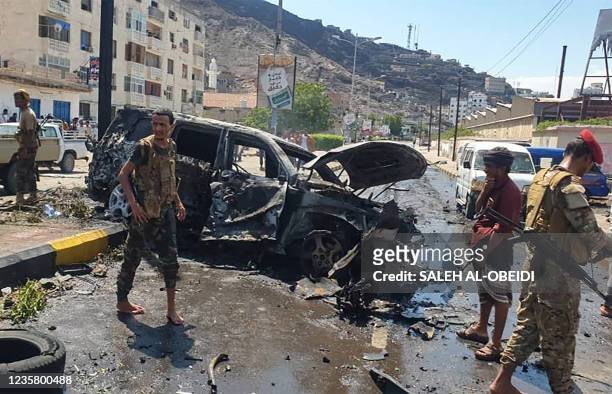 Yemeni security forces gather at the scene of a car-bomb explosion in the heart of Yemen's southern port city of Aden, on October 10, 2021. - Five...