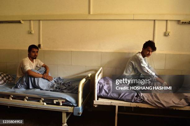 Abbas along with another victim who were injured in October 8 suicide bombing at the Gozar-e-Sayed mosque, rest inside a regional hospital in Kunduz...