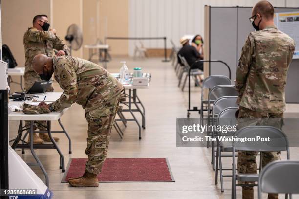 Soldiers file paperwork before being administered their COVID-19 vaccinations by Army Preventative Medical Services on September 9, 2021 in Fort...