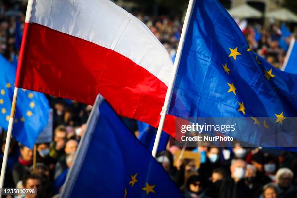 And Polish national flags are seen during 'We're staying in EU' demonstration at the Main Square in Krakow, Poland on October 10, 2021. The pro-EU...