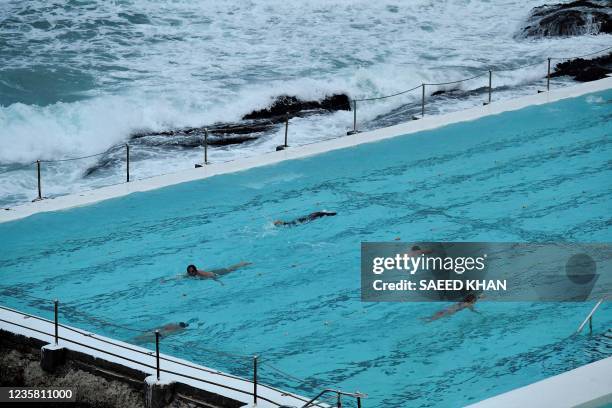 People swim in a pool at Bondi Icebergs Club at the end of a 106-day lockdown against Covid-19 coronavirus in Sydney on October 11, 2021.