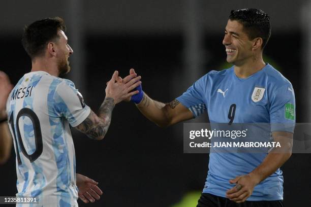 Argentina's Lionel Messi greets Uruguay's Luis Suarez before the start of the South American qualification football match for the FIFA World Cup...