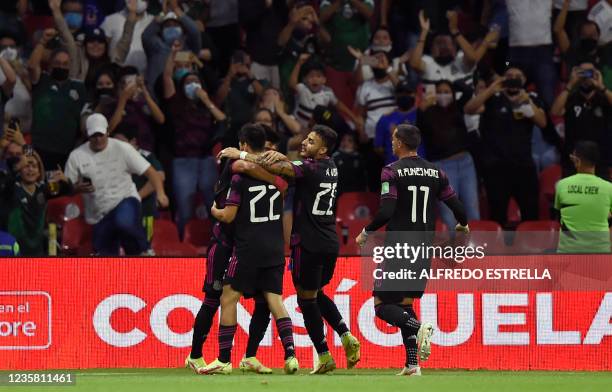 Mexico's Hirving Lozano celebrates with teammates after scoring against Honduras during their Qatar 2022 FIFA World Cup Concacaf qualifier match at...