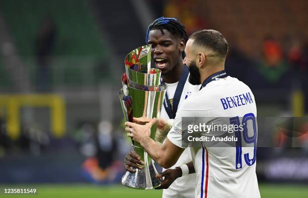 Paul Pogba and Karim Benzema , of France, hold the trophy as they celebrate at the end of the UEFA Nations League football tournament final match...