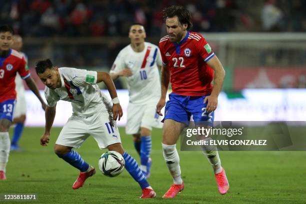 Paraguay's Angel Romero and Chiles' Ben Brereton vie for the ball during the South American qualification football match for the FIFA World Cup Qatar...