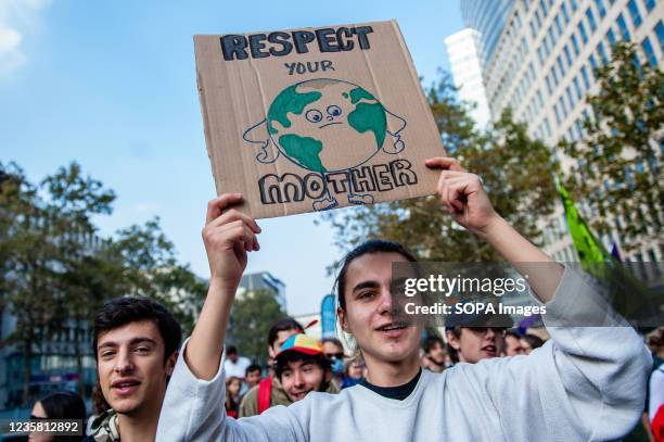 Protester holds a placard while marching through the streets during the demonstration. After a year and a half, Youth for the Climate the...