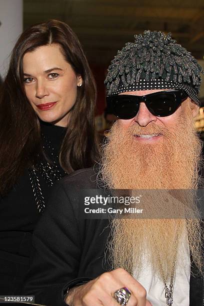 Musician/vocalist Billy Gibbons of ZZ Top signs bottles of Pura Vida Tequila as his wife Gilligan Gibbons looks on at Gabriel's Liquor on January 28,...