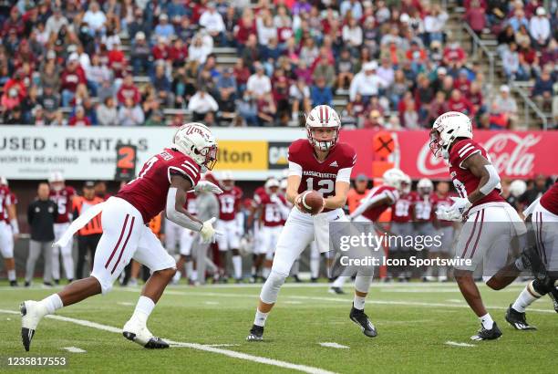 UMass Minutemen quarterback Brady Olson , UMass Minutemen running back Ellis Merriweather and UMass Minutemen wide receiver Eric Collins in action...