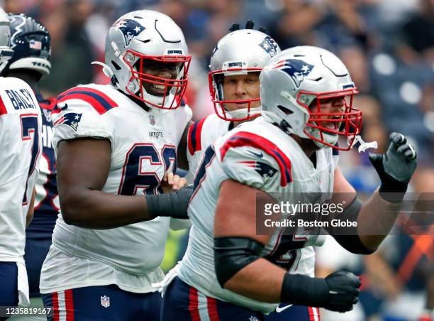 Houston, TX New England Patriots place kicker Nick Folk is in the center as offensive linemen William Sherman and Ted Karras celebrate his the game...