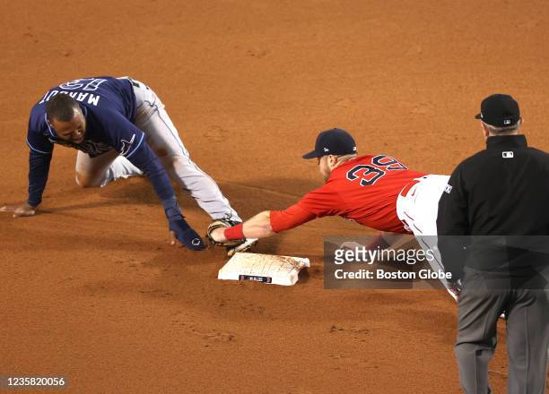 Rays Manuel Margot is tagged out trying to steal to second base by Christian Arroyo in the 10th inning. The Boston Red Sox host the Tampa Bay Rays in...