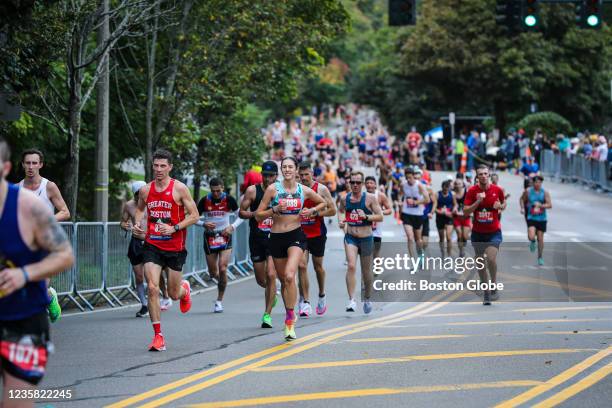 Runners begin the climb up Heartbreak Hill during the 125th running of the Boston Marathon in Newton, MA on Oct. 11, 2021.