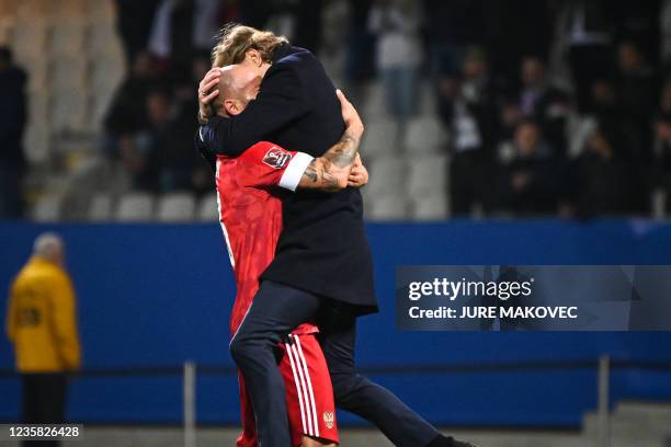 Russias head coach Valeri Karpin celebrates with Fedor Kudryashov after winning the 2022 FIFA World Cup qualifier group H football match between...