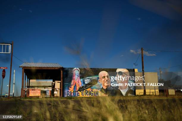 Mural of billionaire Amazon founder Jeff Bezos and his brother Mark Bezos with a Blue Origin rocket in Van Horn, Texas on October 11, 2021. - Blue...