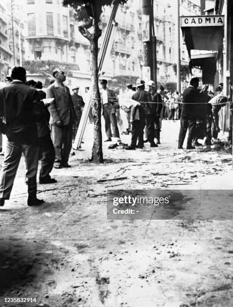 Policemen and rescuers work on the scene of an attack on June 4, 1957 at a trolleybus stop, rue Sadi Carnot in Algiers while three bombs exploded...